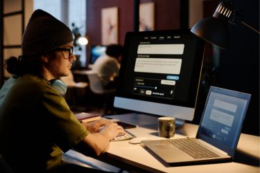 Man using Ai in two computers