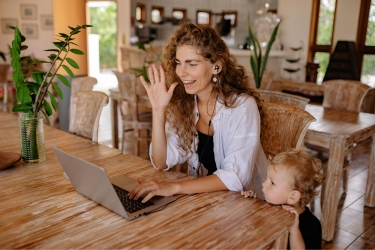 Woman working from home with her child