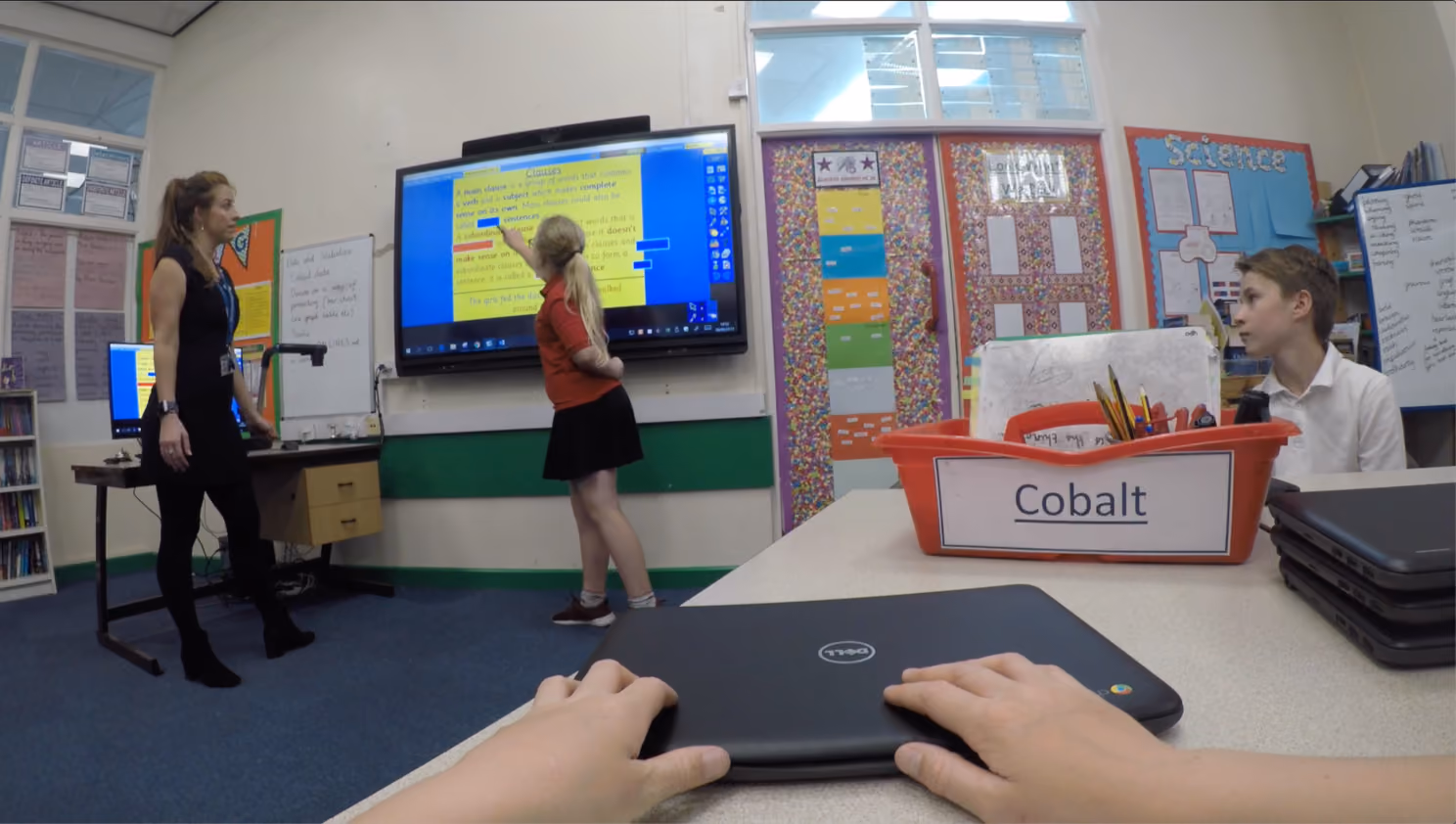 A school pupil using an ActivInspire lesson activity in a classroom