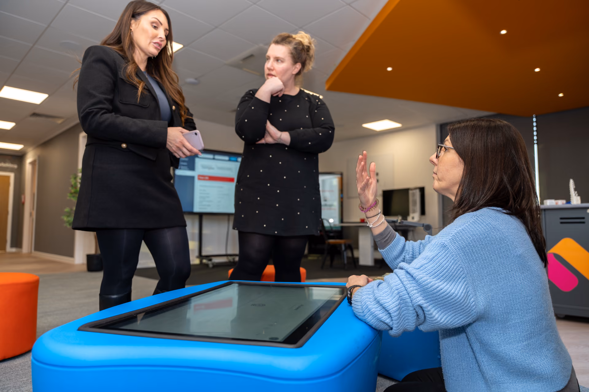 A consultant demonstrating a new piece of technology to customersy
