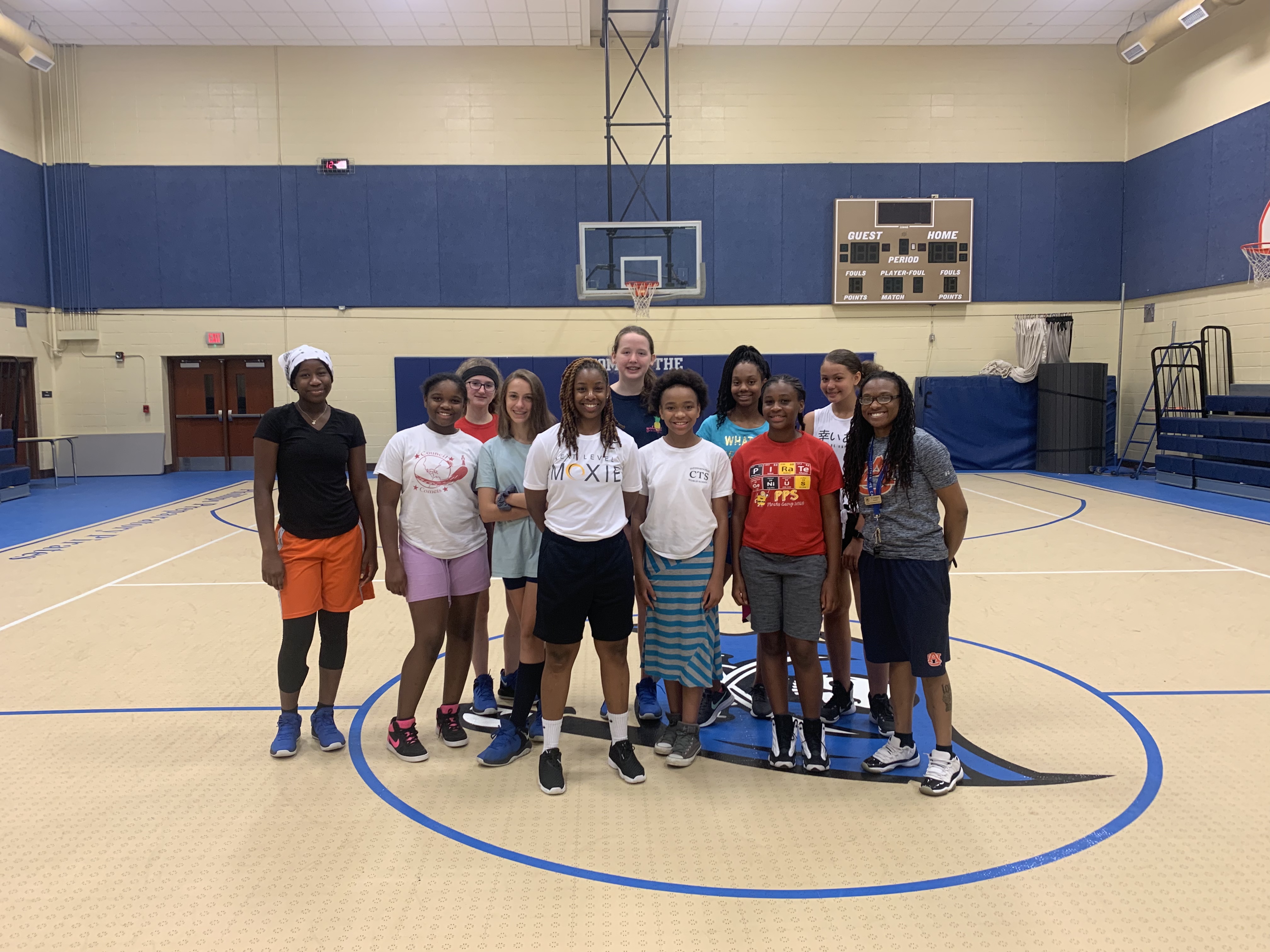 Three women standing on stage at the ESPN Women+Sports Summit with logos for Toyota and Gatorade behind them.