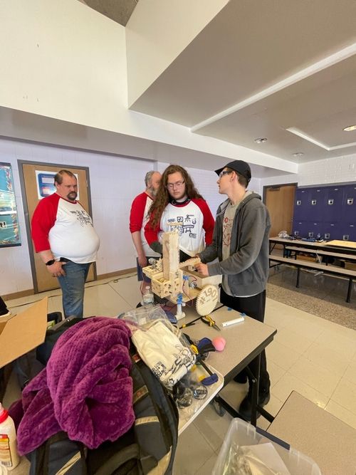 A group of people standing around a table
