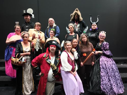 A group of people dressed in costumes posing for a picture