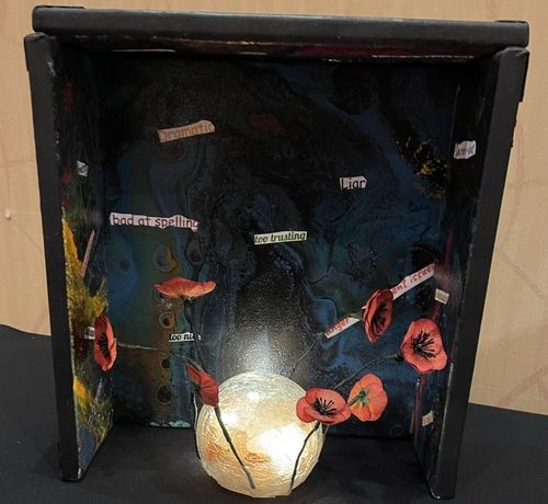 A picture of a vase with red flowers on it