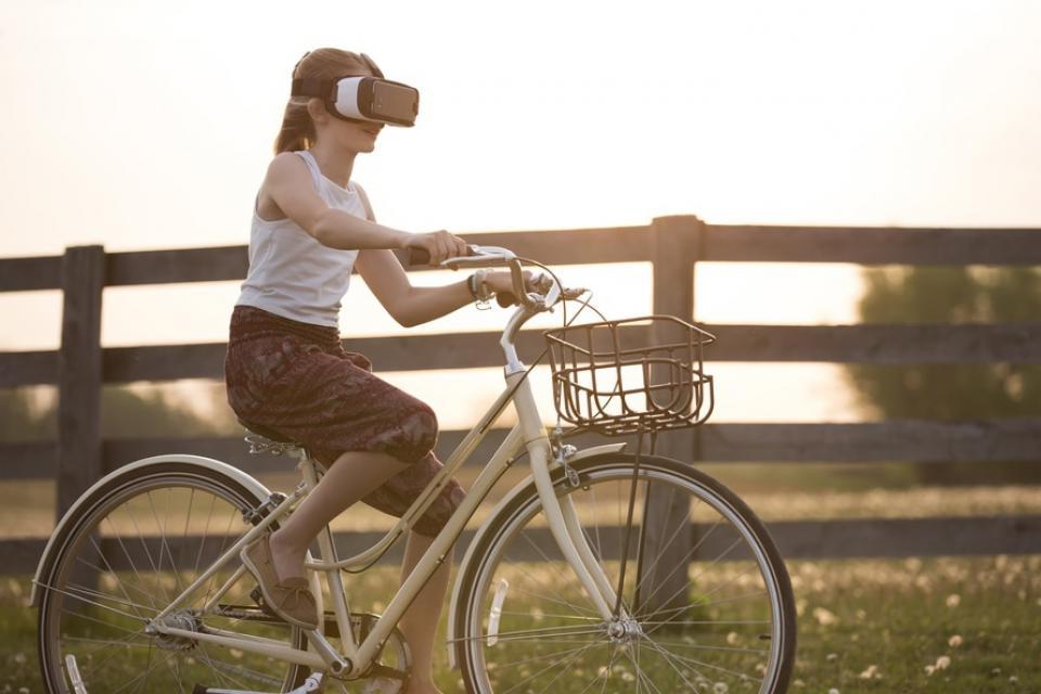 girl riding a bike with VR helmet