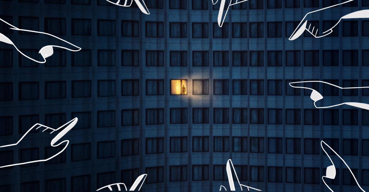Man in a window with fingers pointing at him