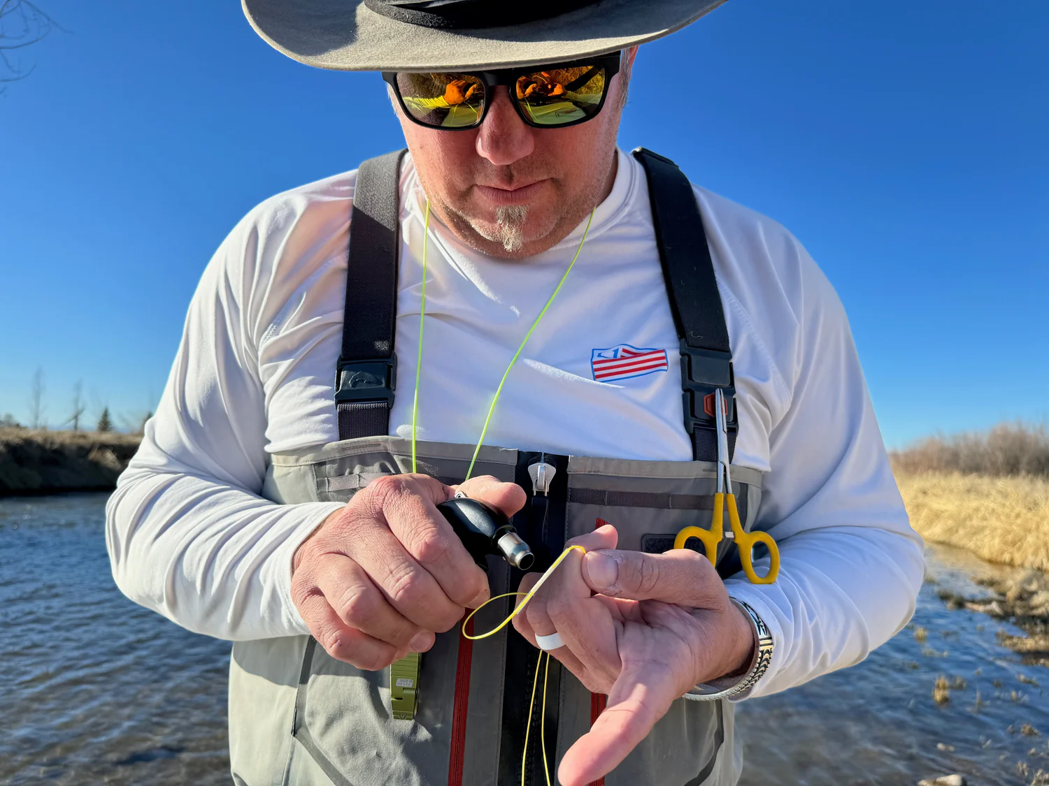 Angler using RestorLine to repair a fly line.