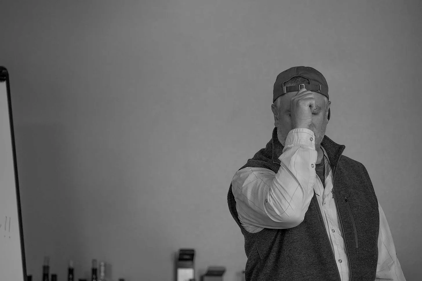 Man holding his fist up to his forehead, as he attempts to show how a fly cast works.