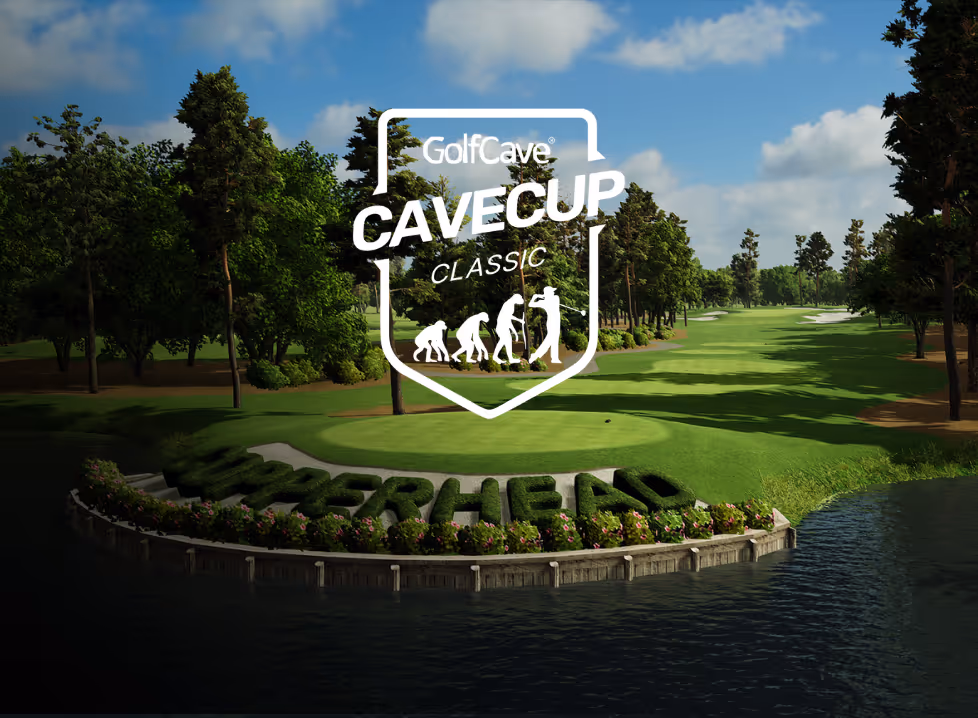 Two men playing golf at the GolfCave. One man is over the ball about to hit while the other watches