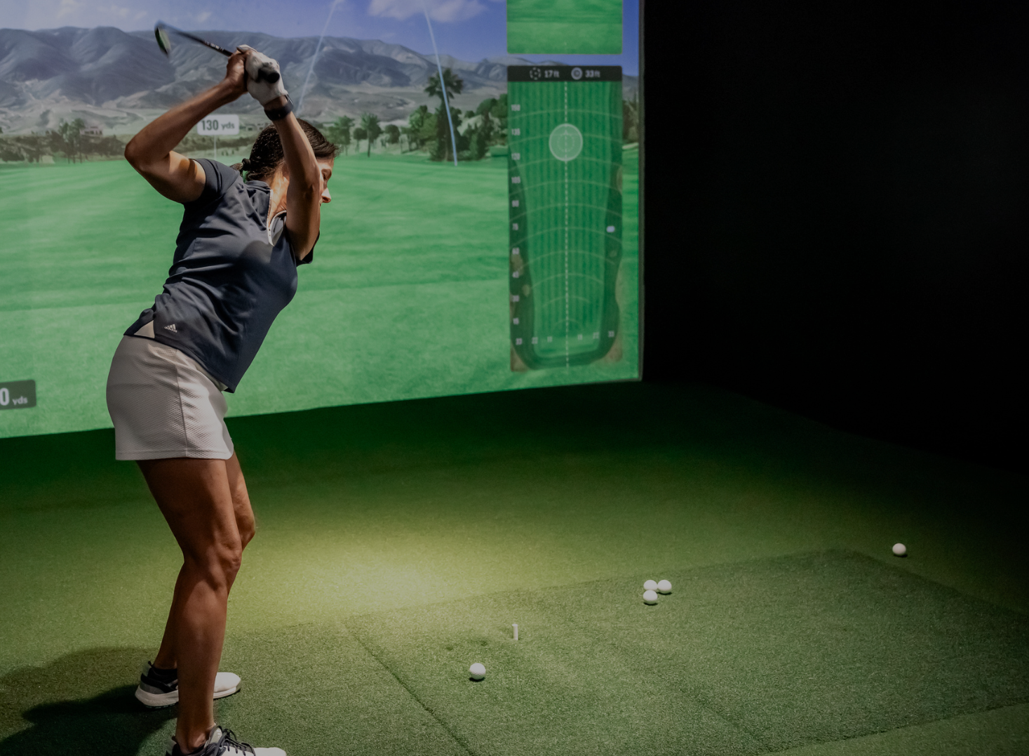Golfer working on indoor golf drills inside a Cave to refine swing and boost performance year-round.