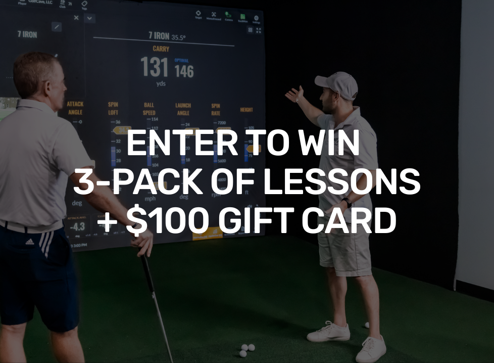 Two men playing golf at the GolfCave. One man is over the ball about to hit while the other watches