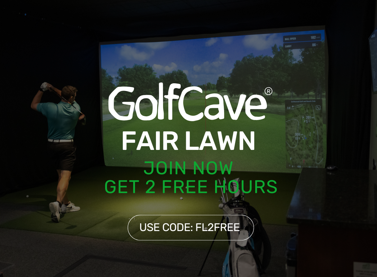 Two men playing golf at the GolfCave. One man is over the ball about to hit while the other watches