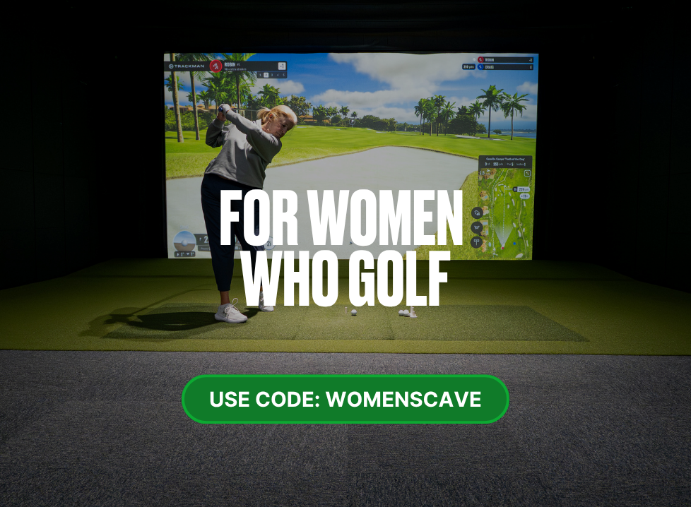 Two men playing golf at the GolfCave. One man is over the ball about to hit while the other watches