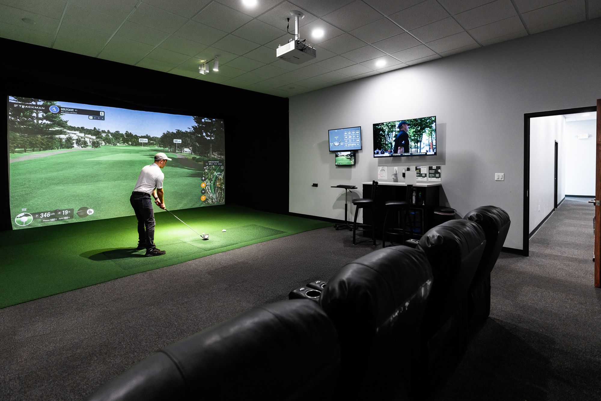 Inside a private simulator cave at GolfCave