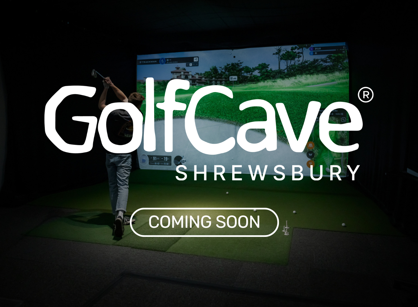 Two men playing golf at the GolfCave. One man is over the ball about to hit while the other watches