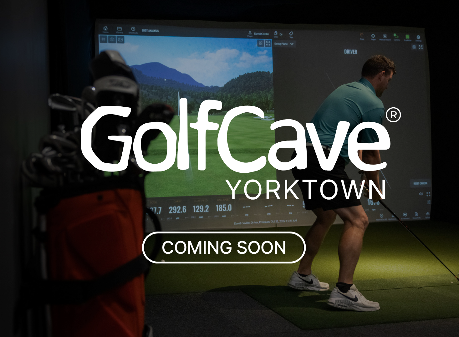 Two men playing golf at the GolfCave. One man is over the ball about to hit while the other watches