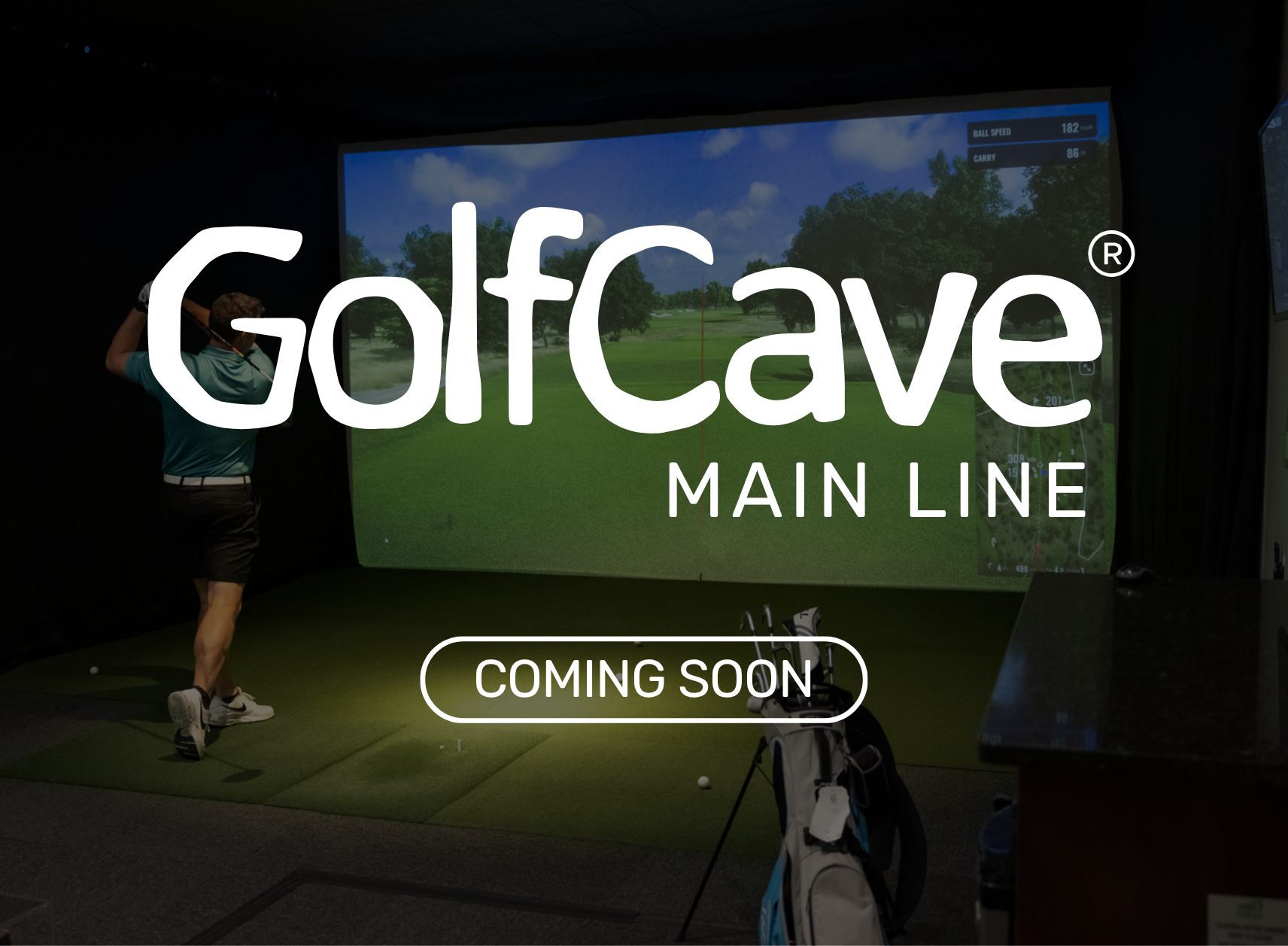 Two men playing golf at the GolfCave. One man is over the ball about to hit while the other watches