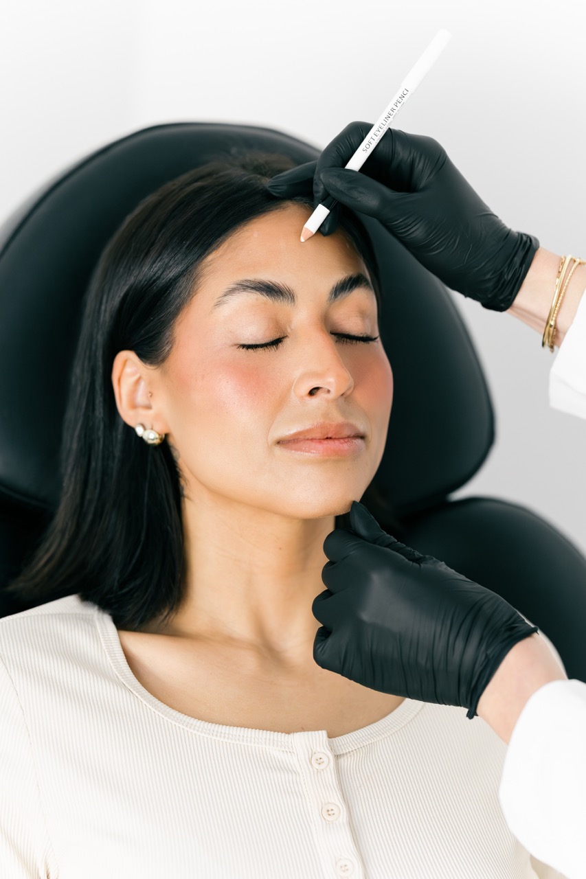 A cosmetic nurse injector holds up a box of Botox Cosmetic