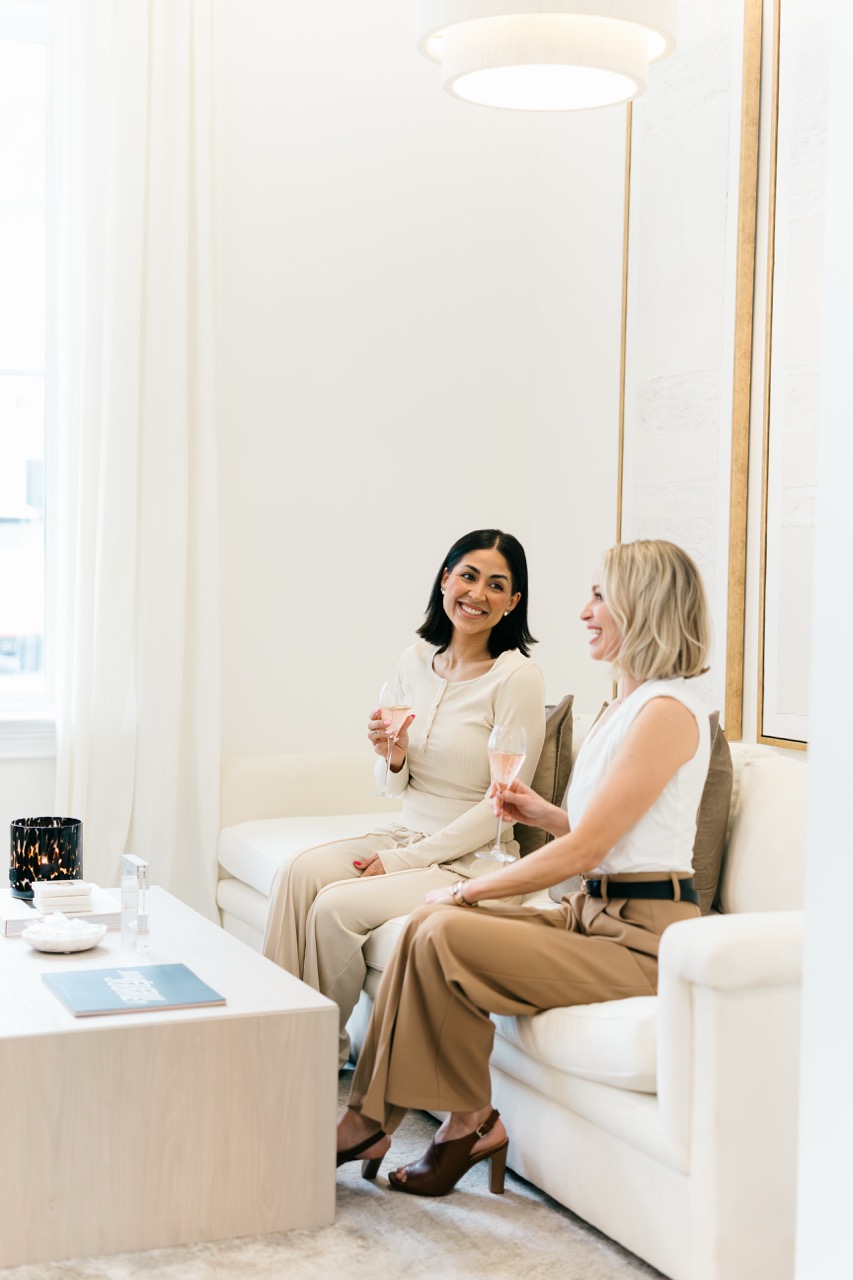 A woman hands a shopping bag to a patient