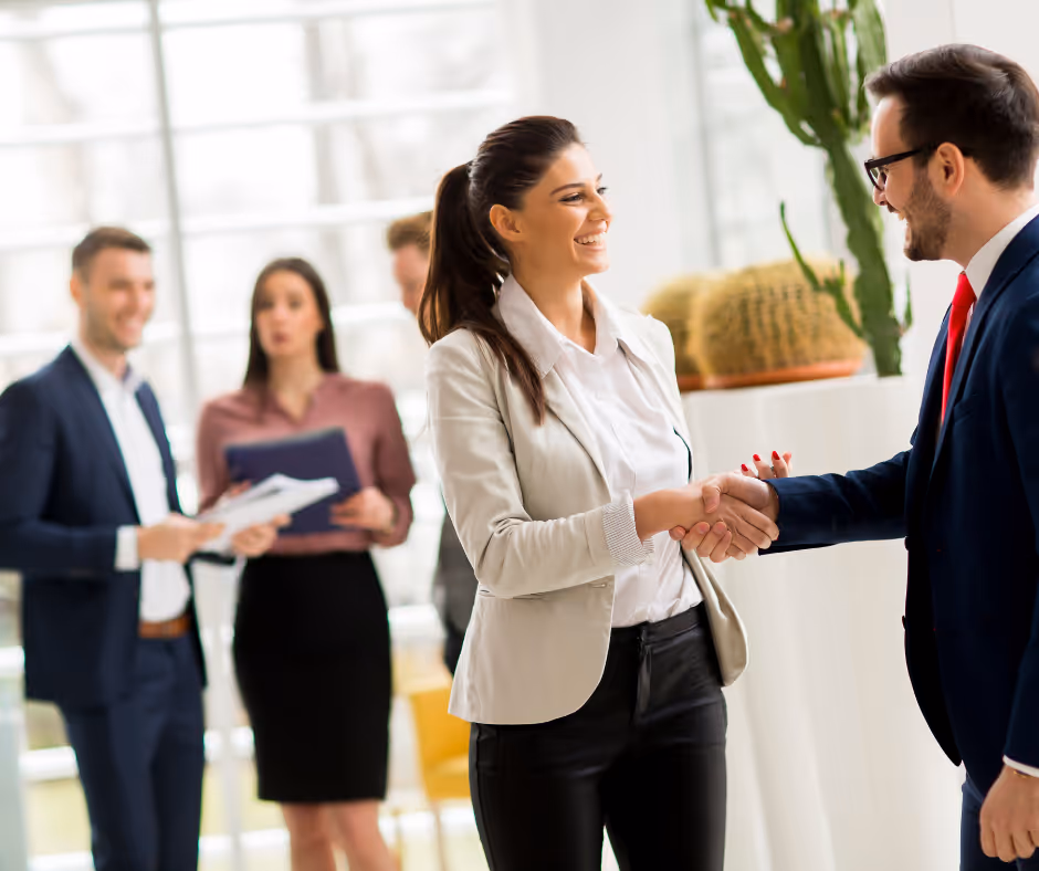 Smiling female lawyer greeting a client who discovered her practice using SEO Marketing for Law Firms.