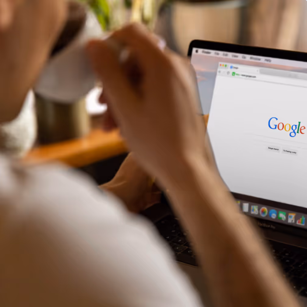 Lawyer reviewing a laptop screen that shows a Google search for SEO Marketing for Law Firms.