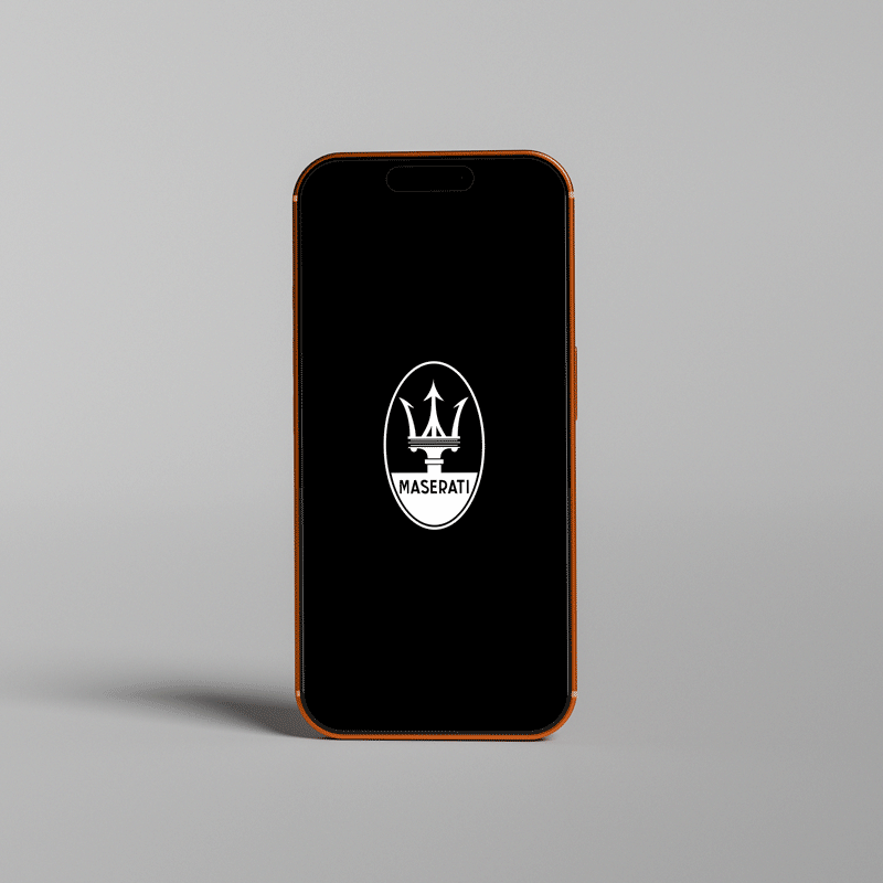 A phone screen with rotating logos on a black background featuring all the luxury automotive brands included in the Grand Collection