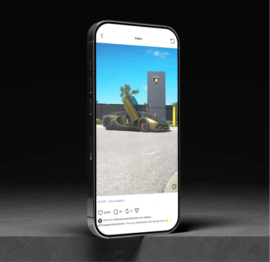 Smartphone showcasing a luxury vehicle video post against a dark backdrop, emphasizing premium digital storytelling