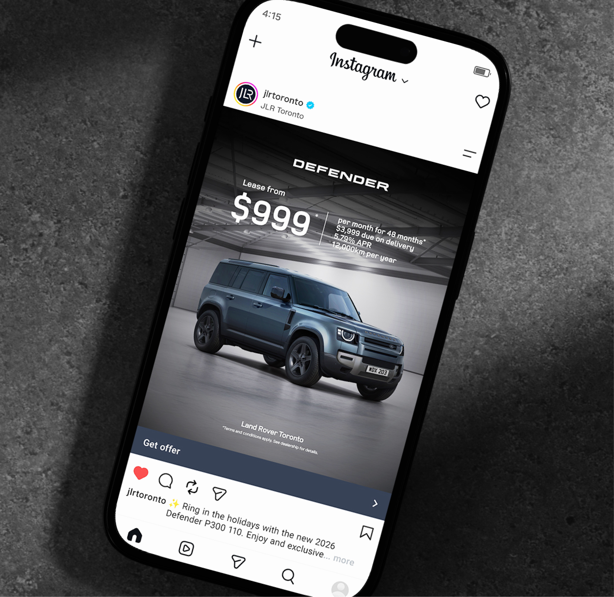 Instagram ad on smartphone promoting Land Rover Defender lease from JLR Toronto, demonstrating digital conversion strategy for luxury SUVs.