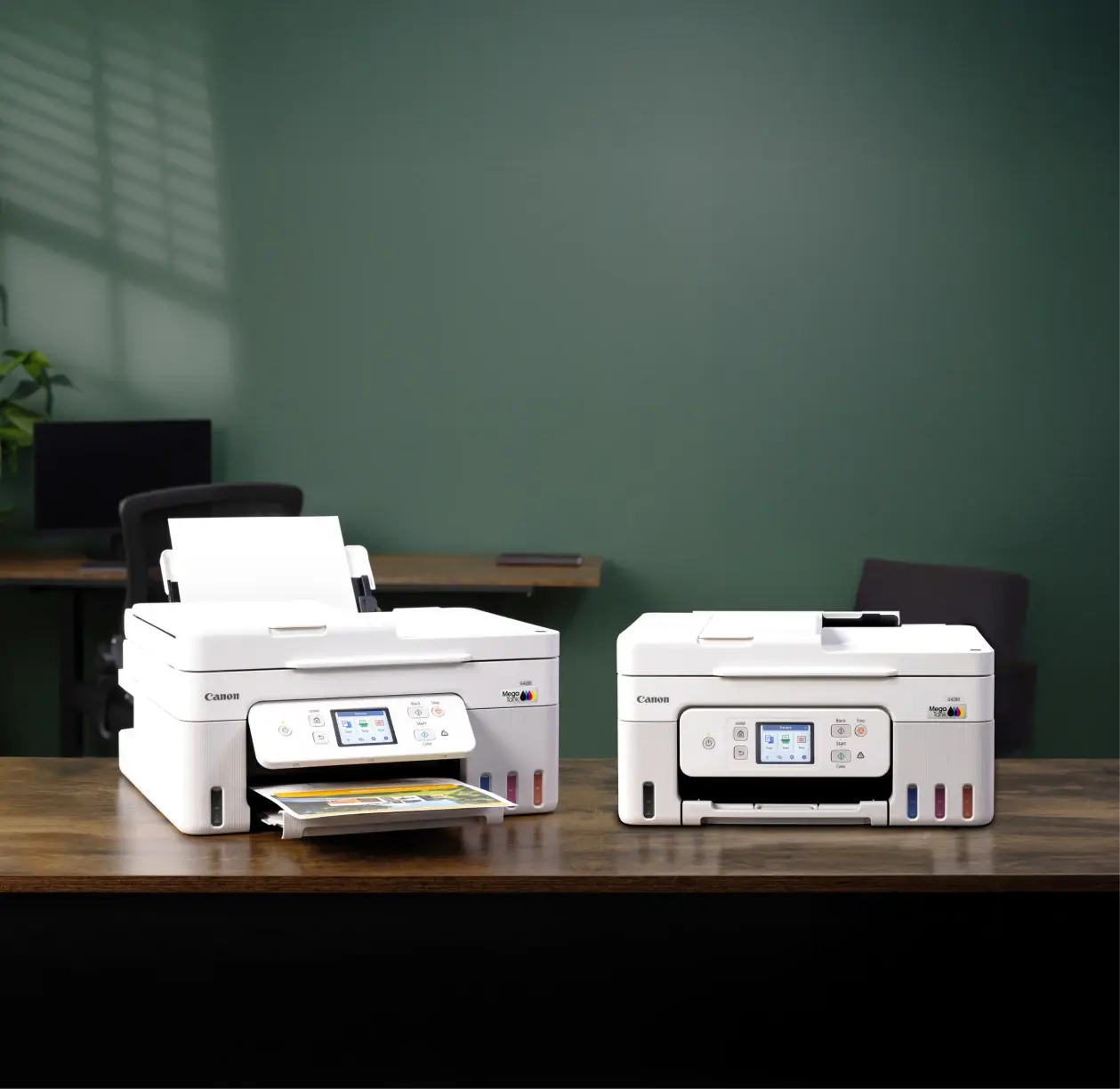 Two Canon MegaTank office printers sit in a small business workspace, highlighting reliable colour printing for daily operations.
