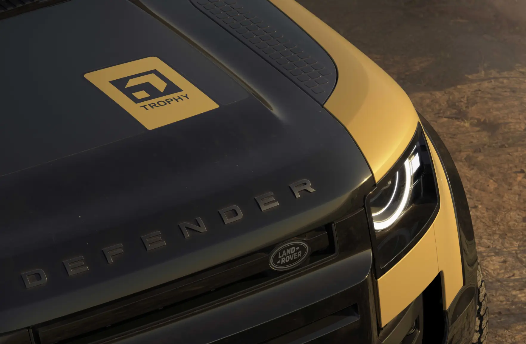 Close-up of a Defender Trophy-branded Defender vehicle, highlighting the adventure competition identity and expedition-ready design.