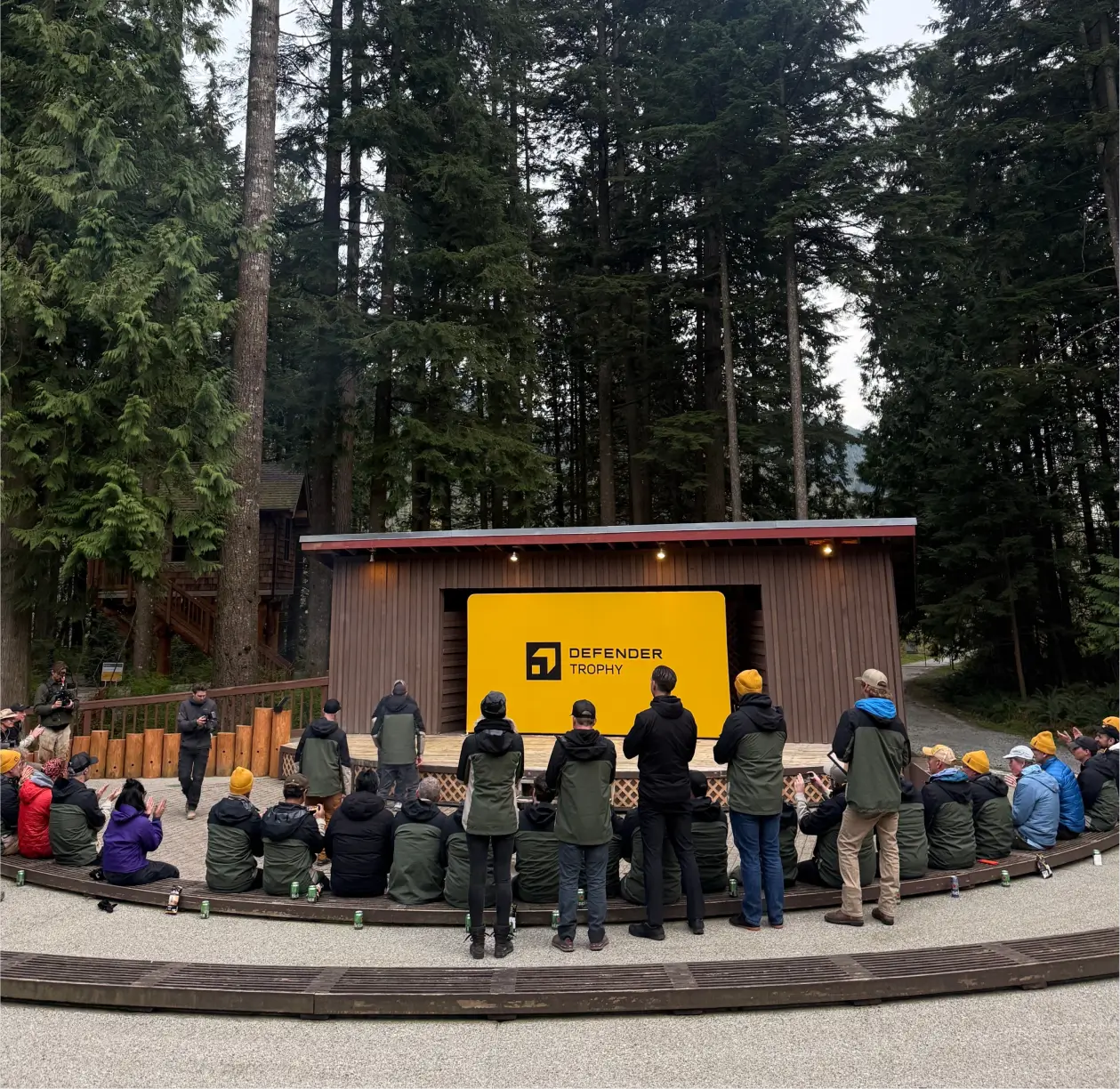 Participants gather at the Defender Trophy awards ceremony, celebrating competition results and the selection of finalists advancing globally.