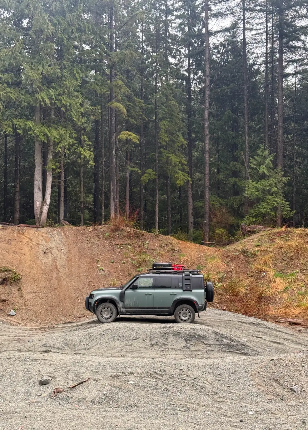 Defender vehicle navigates rugged gravel terrain in Mission, showcasing the demanding landscape used for Defender Trophy competition challenges.