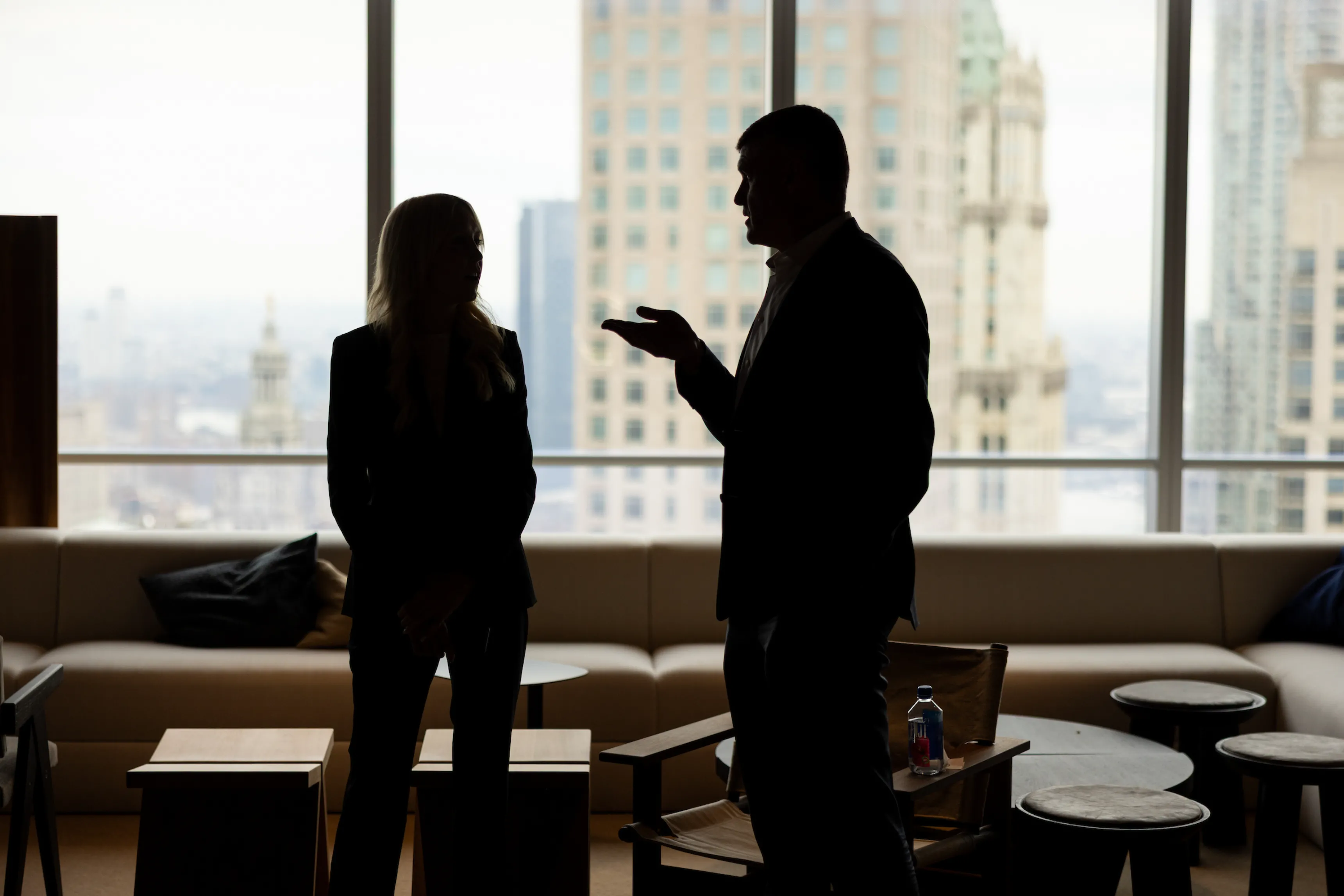 A man sitting at a table in front of a window.
