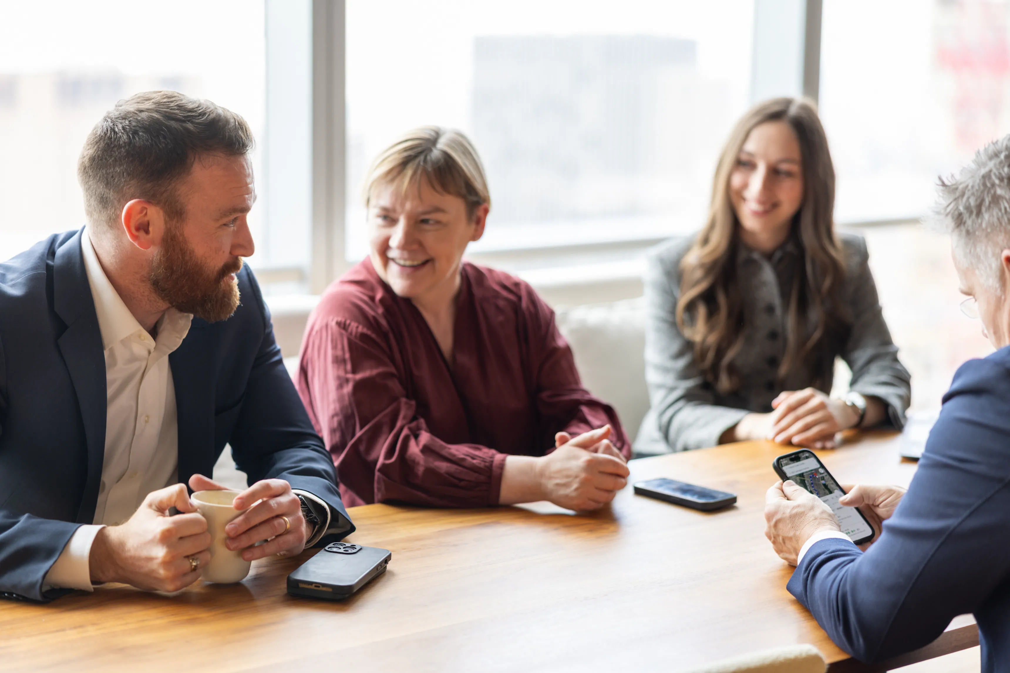 A woman sitting at a table talking to a man.