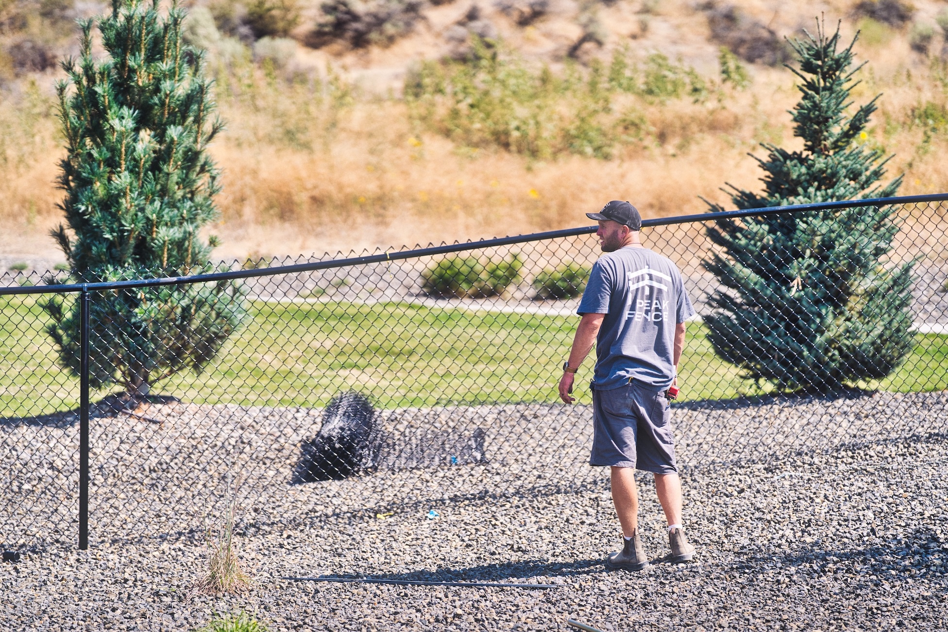 An image of both Peak Fence owners standing in front of a vinyl fence