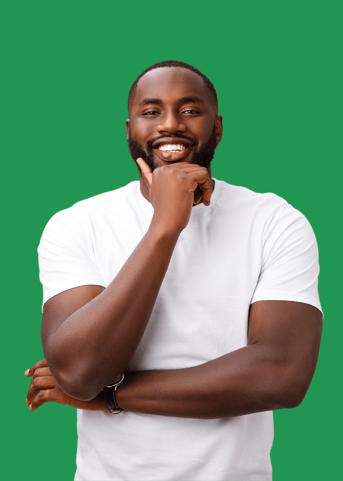 Smiling Black man wearing a white t-shirt with one hand on his chin and the other arm crossed, standing against a solid green background.