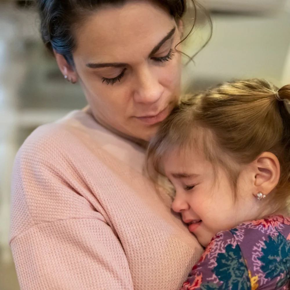 Parent comforting a young child