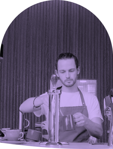 unhappy coffee barista steaming milk