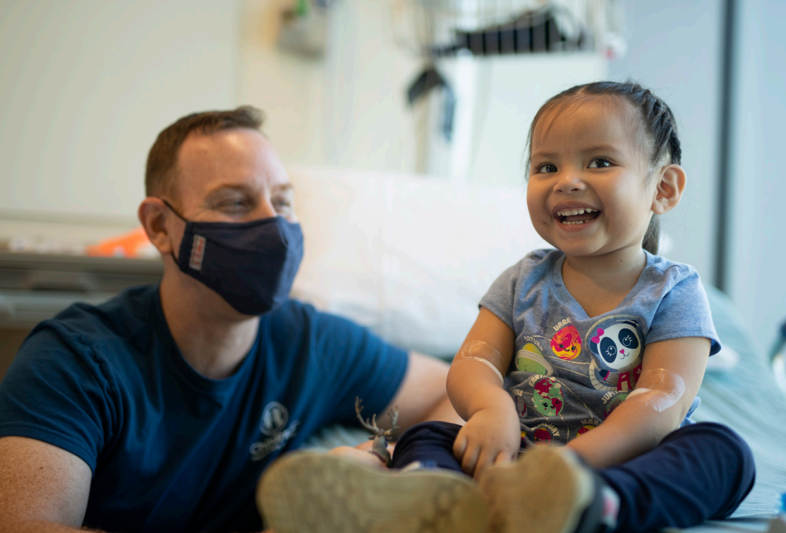 a childrens healthcare of atlanta team member laughs with a young patient