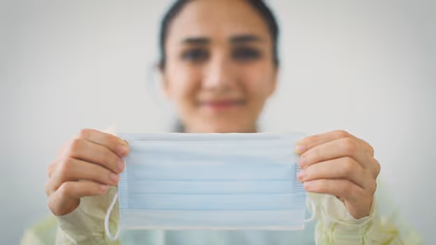 Woman holding protective face mask open
