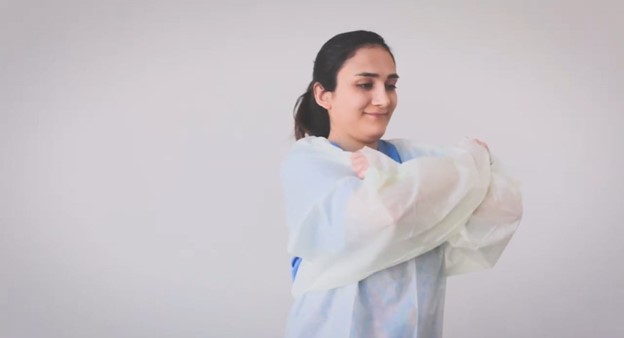Doffing by pulling shoulders of open back gown to release
