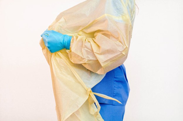Doffing by pulling shoulders of open back gown to release