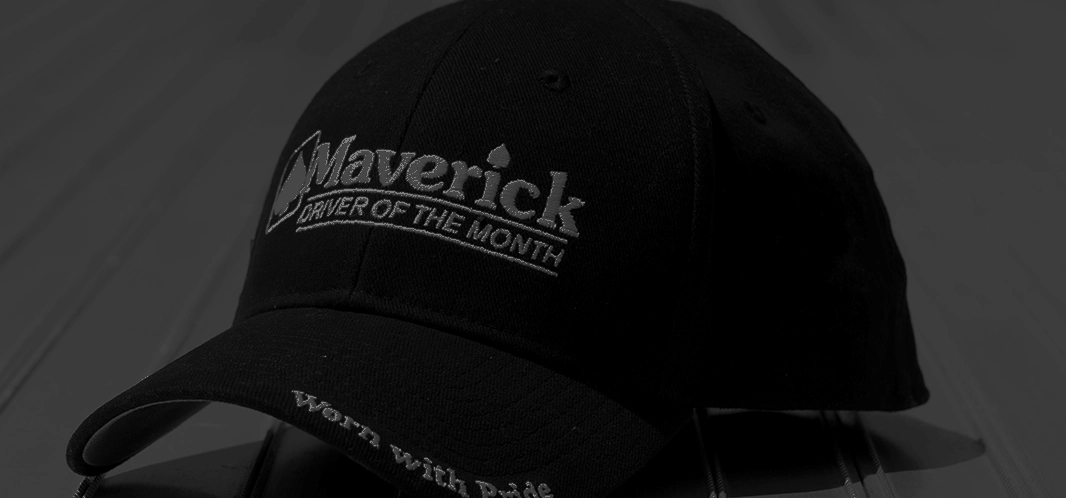 A black Driver of the Month hat on a flatbed trailer