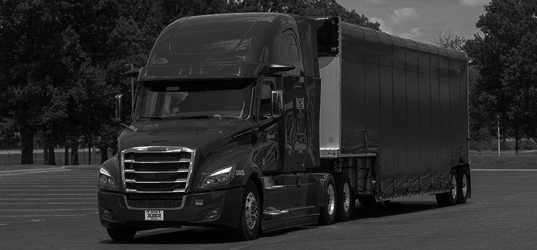 A tractor trailer on a giant parking lot.