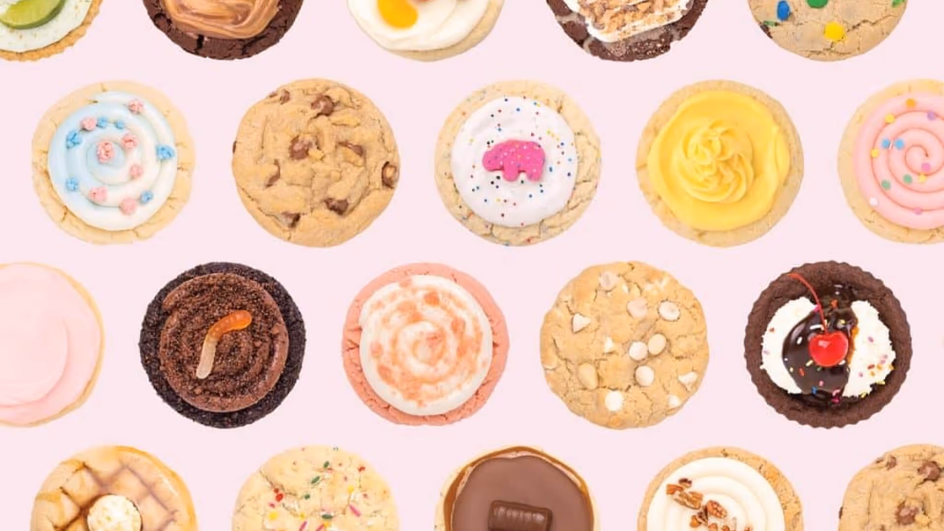 A bunch of different favoured Crumbl cookies on a pink backdrop