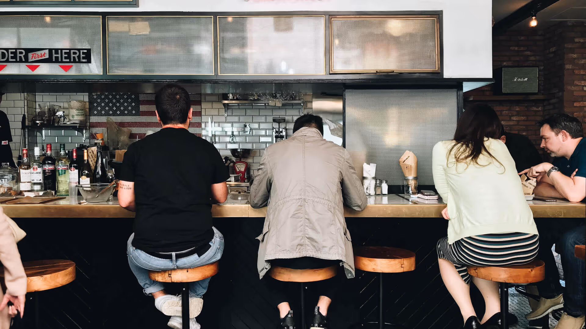 Group of people seated at restaurant bar