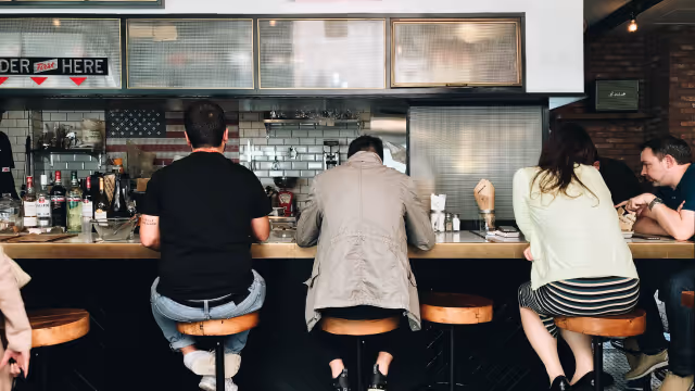 Group of people seated at restaurant bar