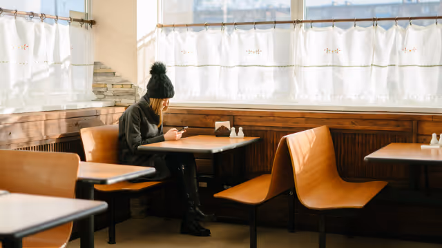 Girl seated at diner-style restaurant table 