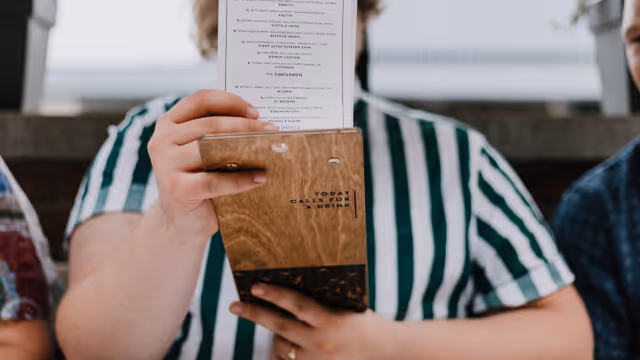 Person reading a physical menu