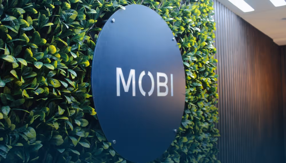 MOBI branded signage on grassy backdrop at the Wellington, NZ office